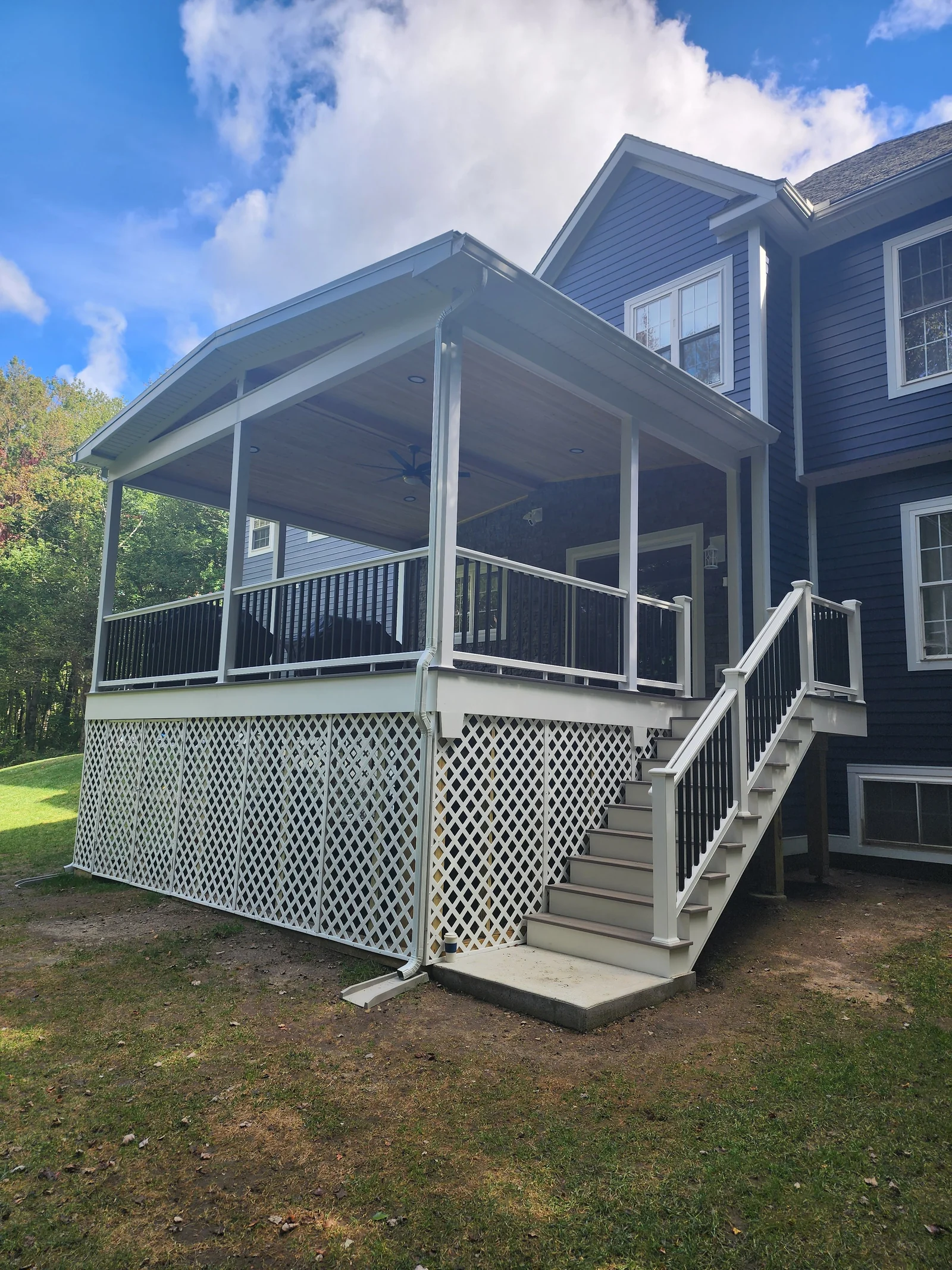 Exterior view of a screened porch and stairs