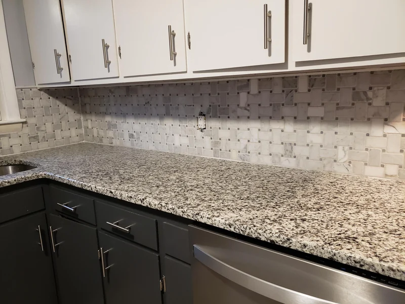 Patterned tile backsplash, countertop, and cabinets